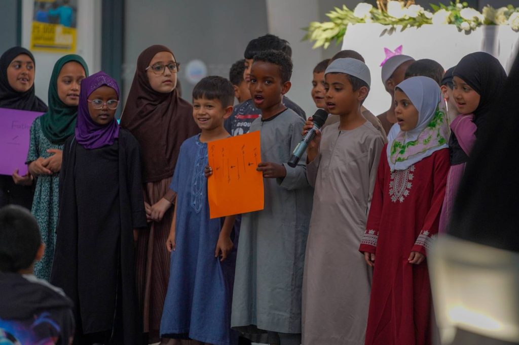 Children taking part in a group presentation at the Green Lane Madrasah Eid Party in Birmingham