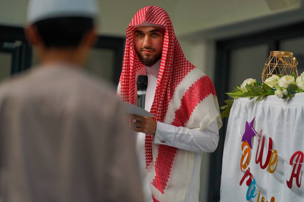 Teacher speaking to students during the Green Lane Madrasah Eid Party at Green Lane Masjid and Community Centre